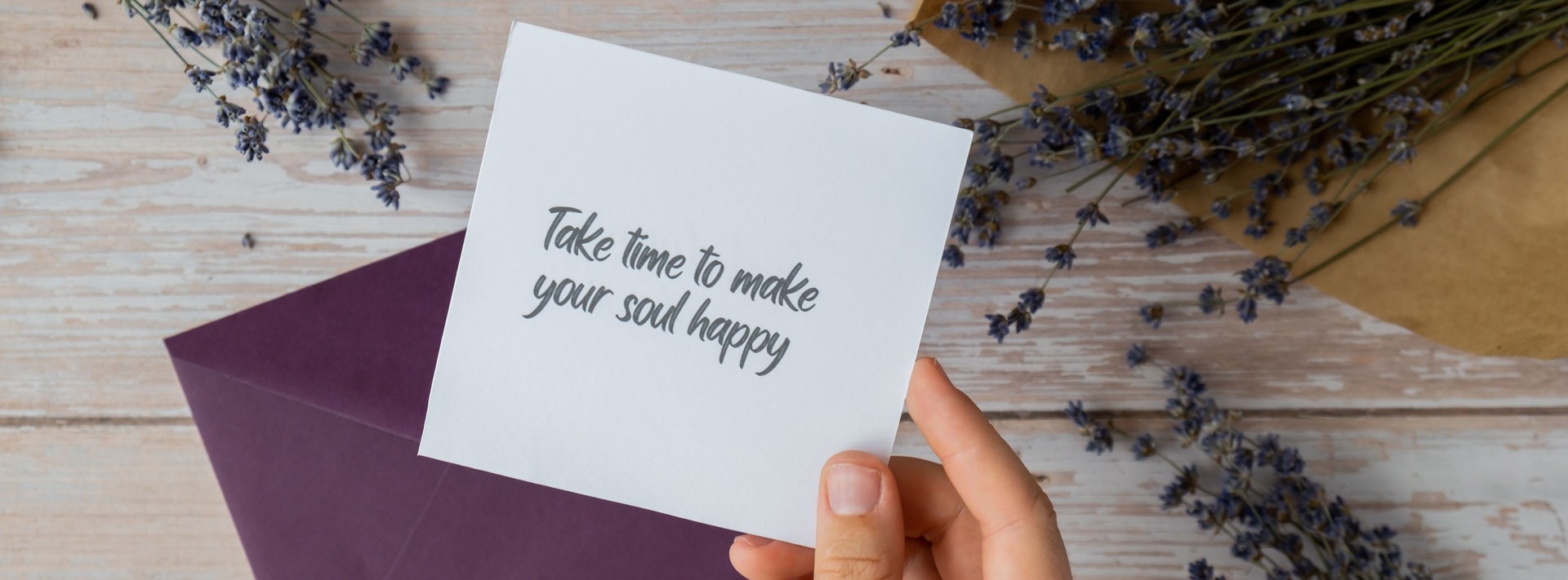 TAKE TIME TO MAKE YOUR SOUL HAPPY text on supportive message paper note reminder from green envelope. Flat lay composition dry lavender flowers. Concept of inner happiness, slowing-down digital detox personal fulfillment