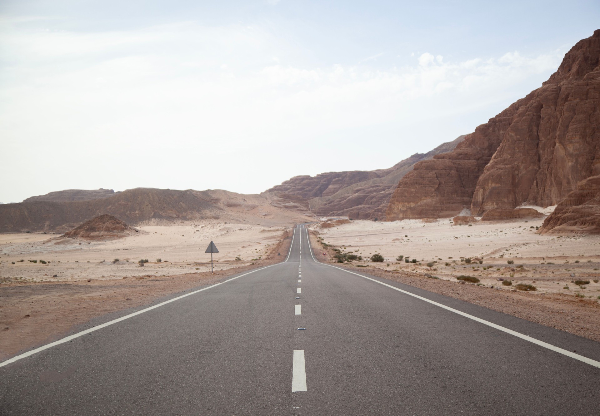 Long asphalt road in the desert.