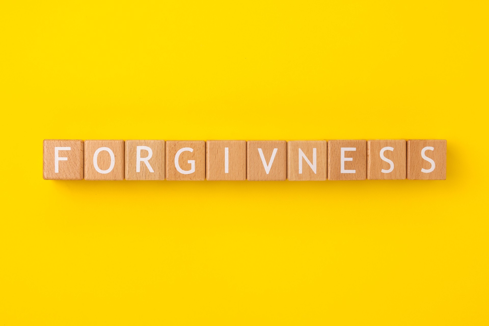 Block Words with Forgiveness on a Yellow Background